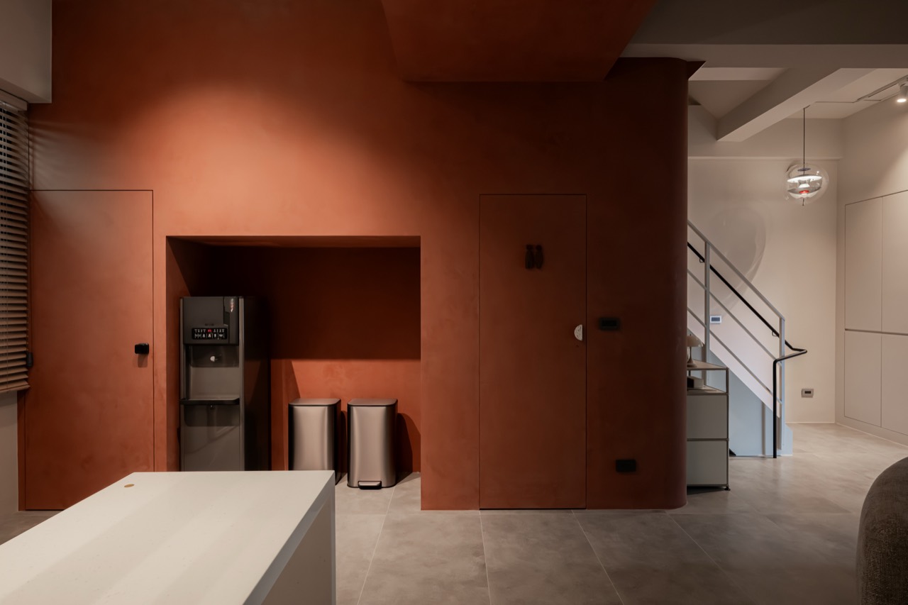 Water dispenser and earthen-red wall in the BAYIT lobby