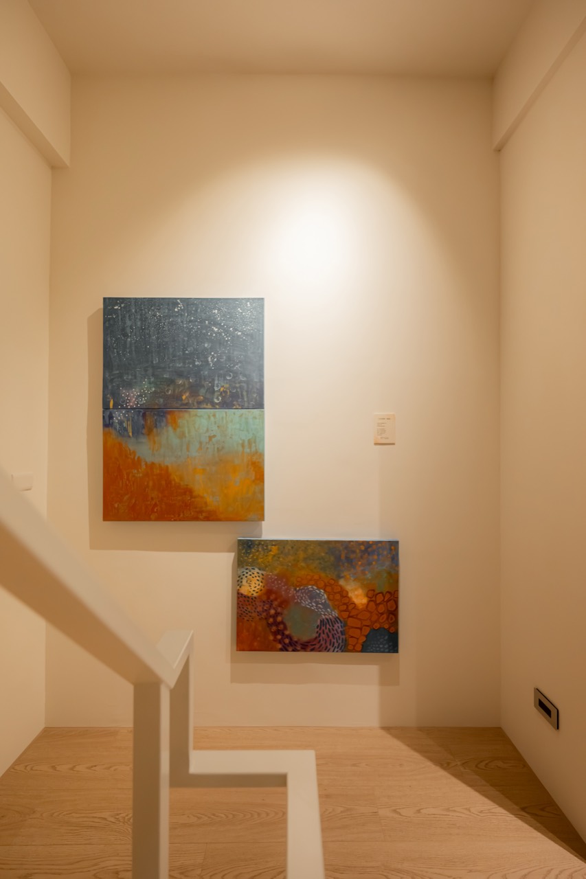 Artworks illuminated at a staircase landing